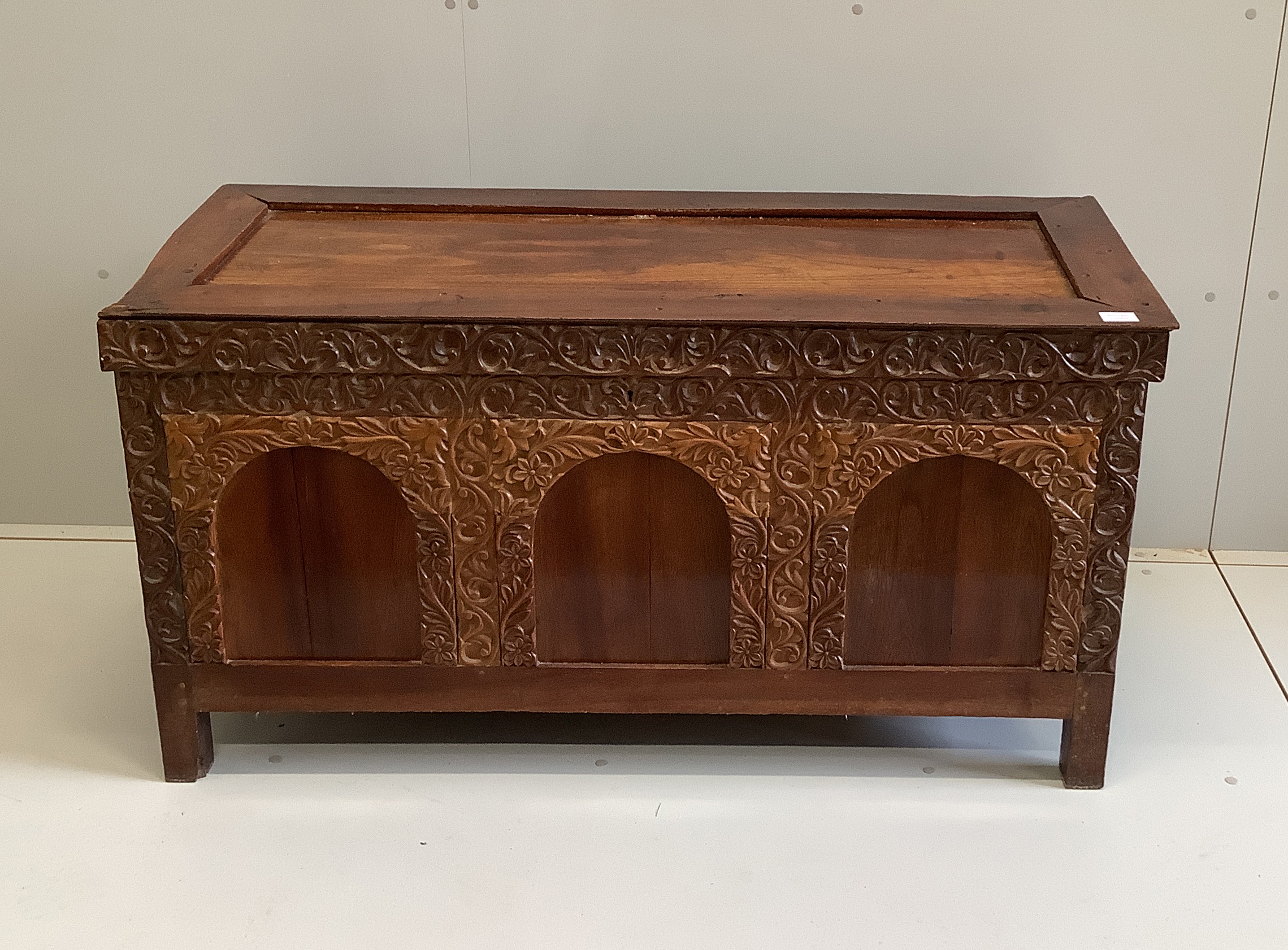 An Indian carved hardwood coffer, width 125cm, depth 53cm, height 66cm